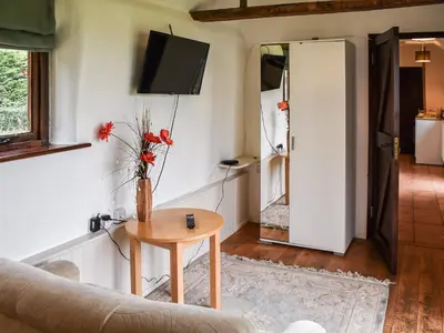 a living room with a couch and a table at The Retreat - Uk48231 in Tibenham