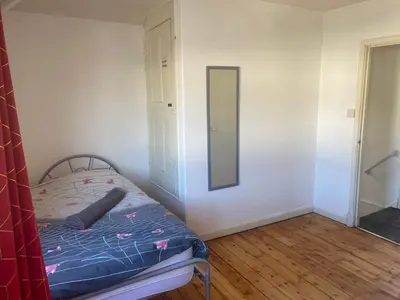 a bedroom with a bed and a mirror on the wall at Charlies House Newmarket - 3 bedroom in Newmarket
