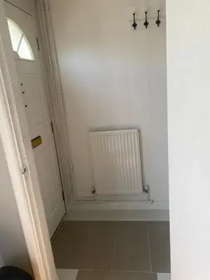 a hallway with a white door and a radiator at Charlies House Newmarket - 3 bedroom in Newmarket