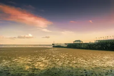 a pier on the beach near the water at 6 Berth Caravan For Hire At Seawick Holiday Park By The Beach Ref 27431Sw in Clacton-on-Sea