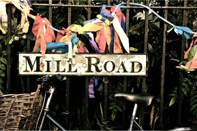a sign that reads mill road on a fence at Cosy Loft Retreat off Vibrant Mill Road - walk to station and City centre in Cambridge