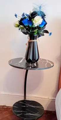 a black and white vase with blue flowers on a table at Number 5 in Harwich