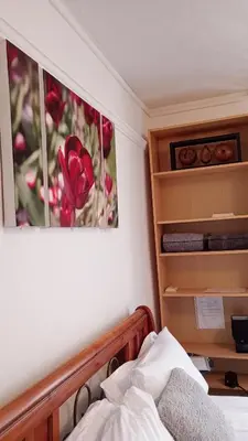 a bedroom with a picture of a flower on the wall at Number 5 in Harwich