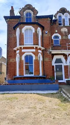 a large brick building with white windows on it at Number 5 in Harwich