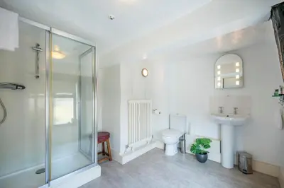 a bathroom with a shower and a toilet and a sink at Cotton Room, The Merchant House, Ipswich in Ipswich