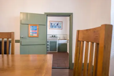 a dining room with a table and a kitchen at Silk Room, The Merchant House, Ipswich in Ipswich