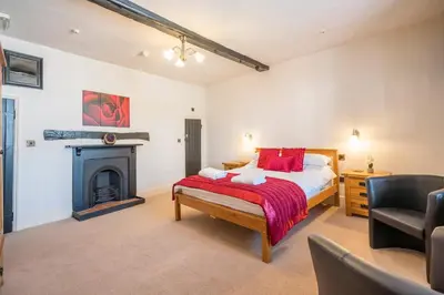 a bedroom with a bed and a fireplace at Wool Room, Merchant House, Ipswich in Ipswich