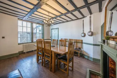 a dining room with a wooden table and chairs at Wool Room, Merchant House, Ipswich in Ipswich