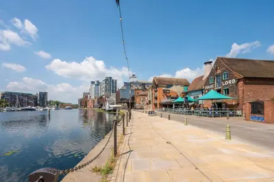 a city street with buildings and a river with buildings at Wool Room, Merchant House, Ipswich in Ipswich