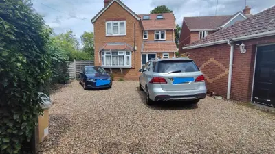 two cars parked in the driveway of a house at Crystalsspace in Braintree