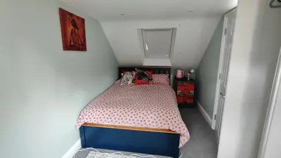a small bedroom with a bed in a attic at Crystalsspace in Braintree