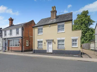 a yellow house on the side of a street at Courtyards in Diss