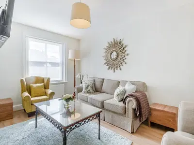 a living room with a couch and a table at Courtyards in Diss