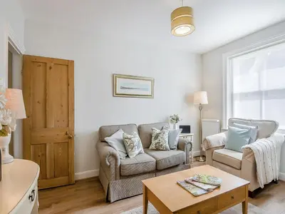 a living room with a couch and two chairs at Courtyards in Diss