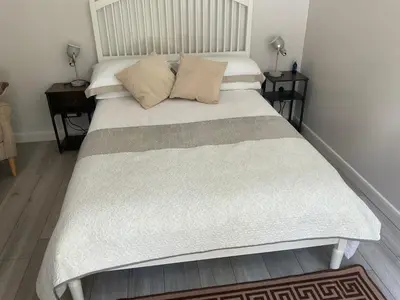 a bed with two pillows on it in a bedroom at The Meadow Garden Guest Room in Newmarket