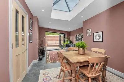 a dining room with a wooden table and chairs at Entire spacious house in BSE in Bury Saint Edmunds