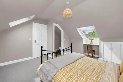 a bedroom with a bed and a window at Entire spacious house in BSE in Bury Saint Edmunds