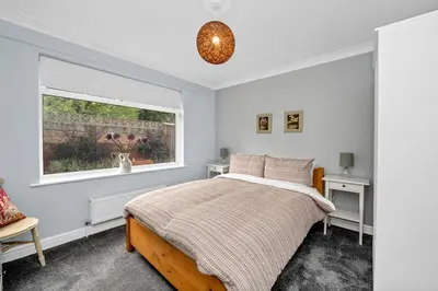 a bedroom with a bed and a window at Entire spacious house in BSE in Bury Saint Edmunds