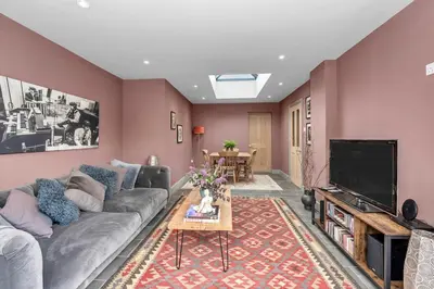a living room with a couch and a tv at Entire spacious house in BSE in Bury Saint Edmunds
