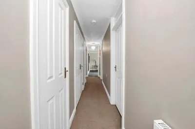 a hallway with white walls and white doors at Entire spacious house in BSE in Bury Saint Edmunds