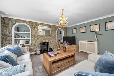 a living room with a couch and a table at Entire spacious house in BSE in Bury Saint Edmunds