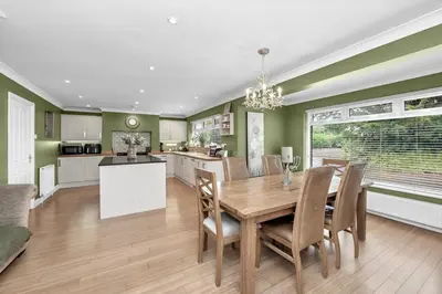 a kitchen and dining room with a wooden table and chairs at Entire spacious house in BSE in Bury Saint Edmunds