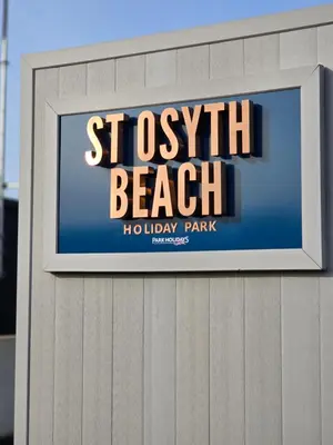 a sign for a beach holiday park on a building at Your Seaside Escape at St Osyth Modern caravan with decking and wifi and parking Nr to Clacton on Sea in Saint Osyth