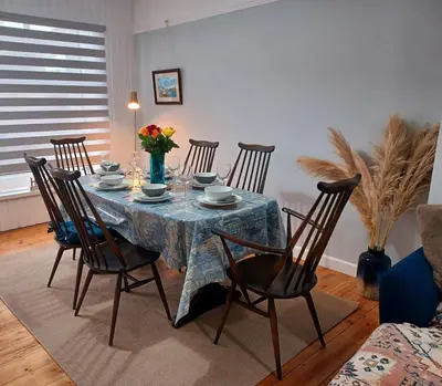a dining room table with chairs and a blue table cloth at Beachside Terrace in Dovercourt