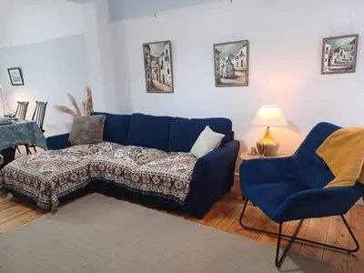 a blue couch and two chairs in a living room at Beachside Terrace in Dovercourt