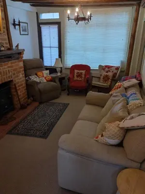 a living room with a couch and a fireplace at The Old Sweet Shop in Harwich