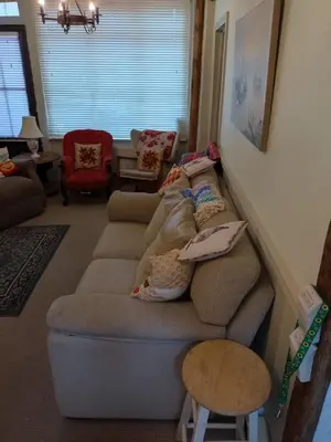 a living room with a couch with pillows on it at The Old Sweet Shop in Harwich