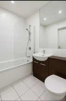 a bathroom with a toilet and a sink and a shower at Modern 2 Bed Flat with parking Next to Basildon Station in Laindon