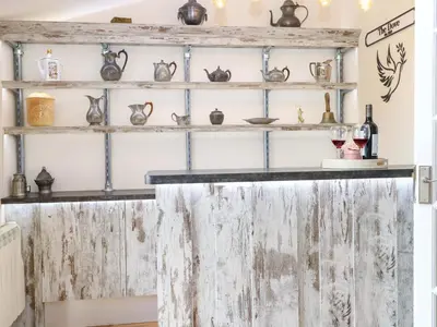 a shelf filled with antiques and pottery at Honeysuckle Cottage in Swaffham
