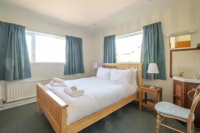a bedroom with a bed with towels on it at 18 Linden Road - sleeps 5 - Less than a mile from the Aldeburgh Beach and a Vibrant High Street in Aldeburgh