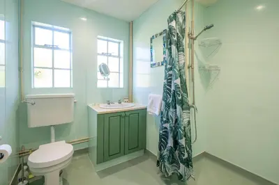 a bathroom with a toilet and a shower at 18 Linden Road - sleeps 5 - Less than a mile from the Aldeburgh Beach and a Vibrant High Street in Aldeburgh