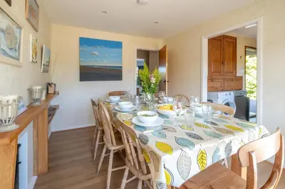 a kitchen and dining room with a table and chairs at 18 Linden Road - sleeps 5 - Less than a mile from the Aldeburgh Beach and a Vibrant High Street in Aldeburgh