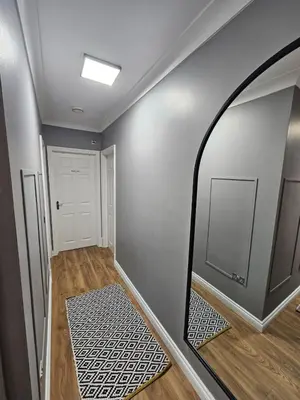 a hallway with a mirror on the wall at Apartment Royston Center in Royston