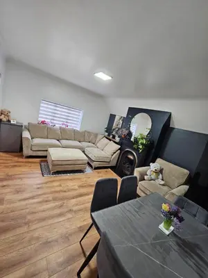 a living room with a couch and a table at Apartment Royston Center in Royston