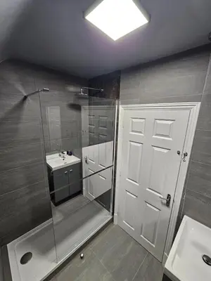 a bathroom with a shower and a sink at Apartment Royston Center in Royston