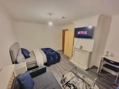 a hotel room with a bed and a sign on the wall at Budget Room Stevenage Town Centre in Stevenage