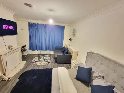 a bedroom with a bed and a couch in a room at Budget Room Stevenage Town Centre in Stevenage