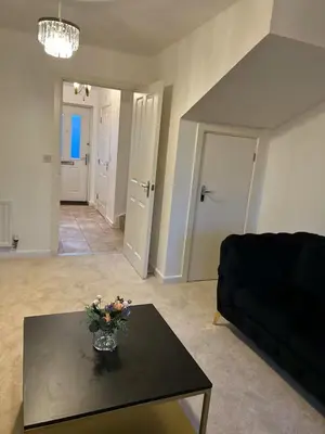 a living room with a black table and a black couch at Stunning 2BR house in Colchester in Colchester