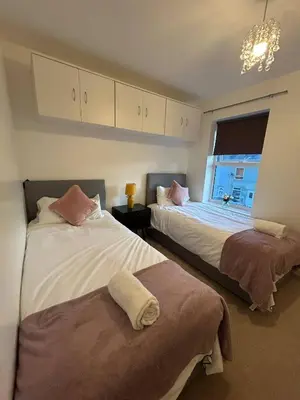a bedroom with two beds and a window at Stunning 2BR house in Colchester in Colchester