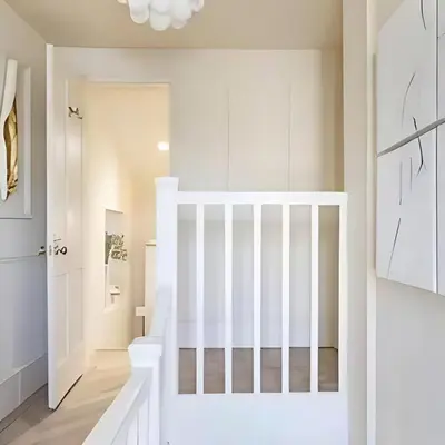 a white staircase in a home with white walls at Stunning house in the heart of Leigh-On-Sea in Leigh-on-Sea