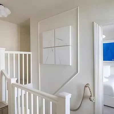 a white staircase in a home with a mirror at Stunning house in the heart of Leigh-On-Sea in Leigh-on-Sea