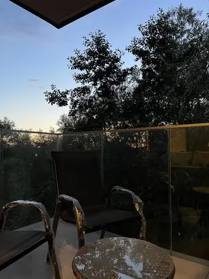 a pair of chairs and a table on a balcony at The Crimsons, with free parking, Harlow in Harlow