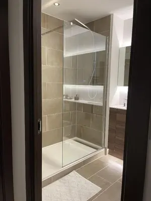 a shower with a glass door in a bathroom at The Crimsons, with free parking, Harlow in Harlow