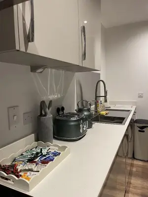 a kitchen with a counter top with a stove top oven at The Crimsons, with free parking, Harlow in Harlow