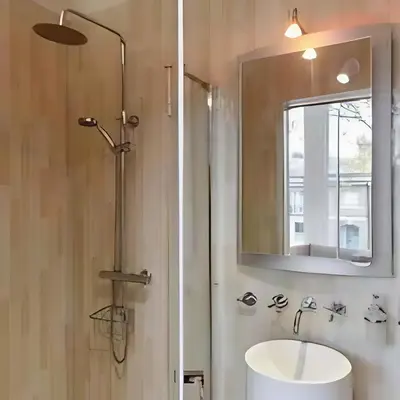 a bathroom with a sink and a mirror at Elegant, Victorian End of Terrace Town House in Southend-on-Sea