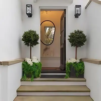 a front door with two trees and a mirror at Elegant, Victorian End of Terrace Town House in Southend-on-Sea